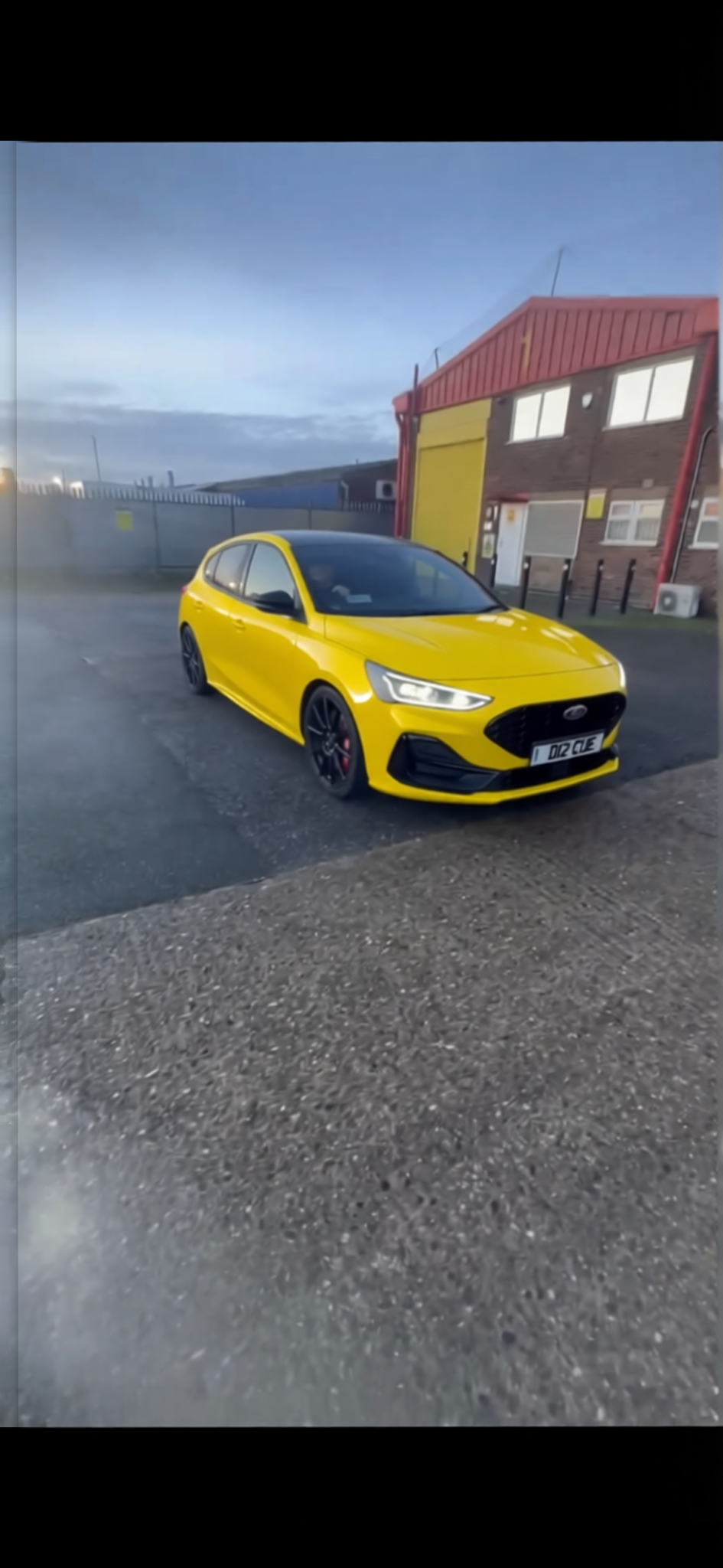 Ford Focus rendered in Racing Yellow gloss paint